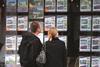 Couple at Estate Agent window 