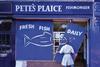 Fishmonger putting up shop front signs