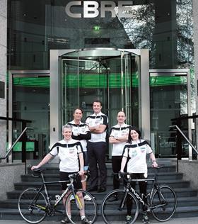 4 cyclists outside CBRE building