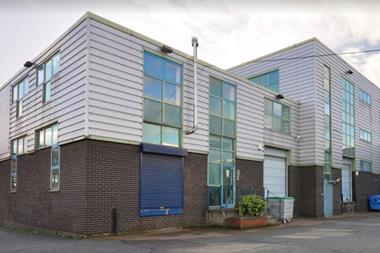 The outside of an industrial scheme with shuttered doors