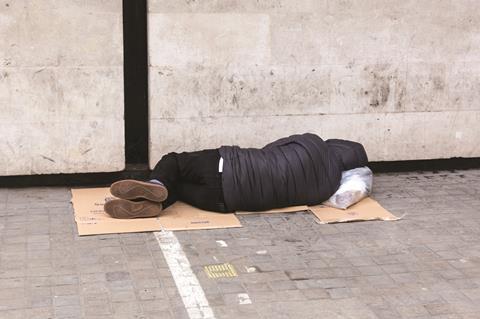 Homeless man sleeping on street shutterstock_1103636513 dominika zara